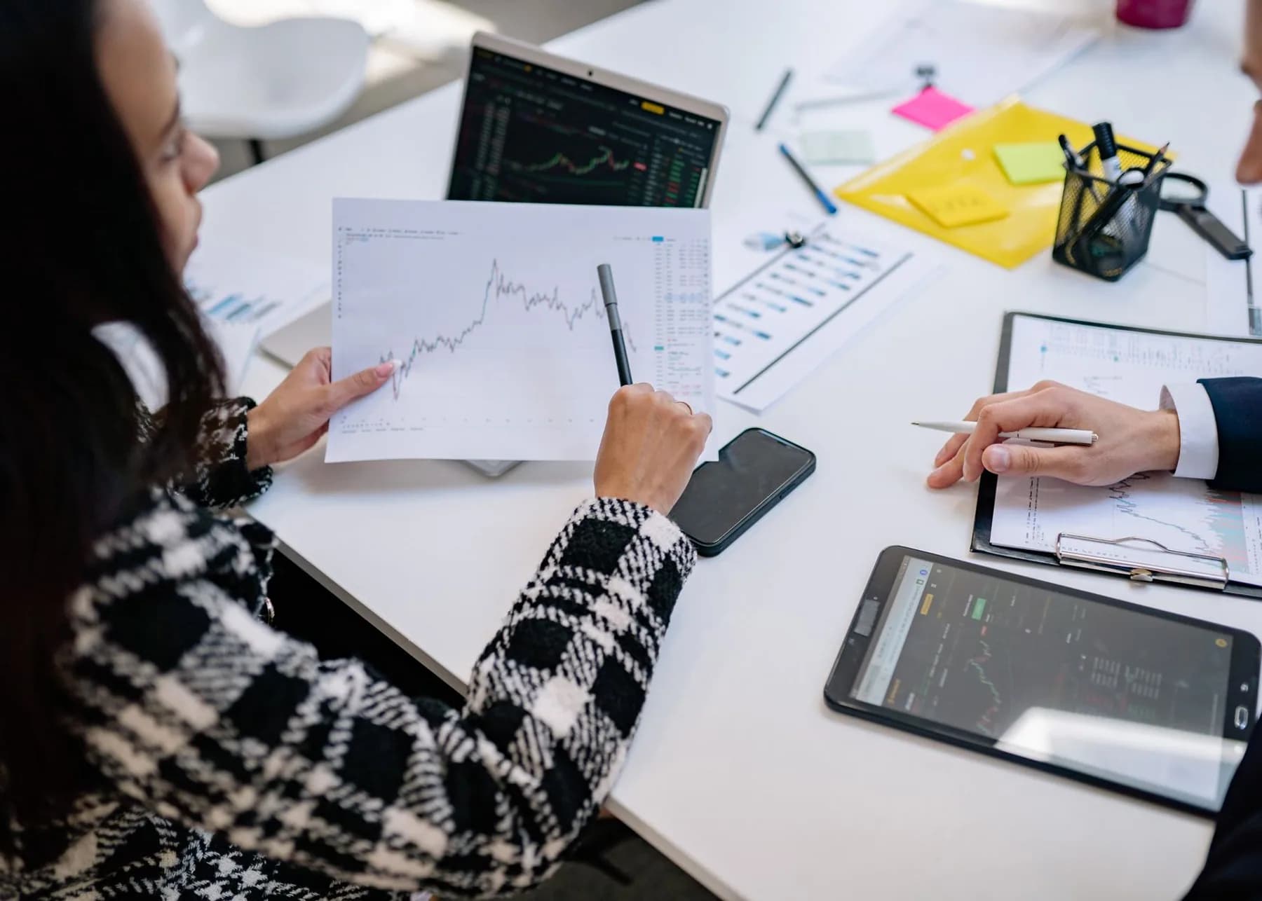 Financial advisers reviewing market reports and performance data together